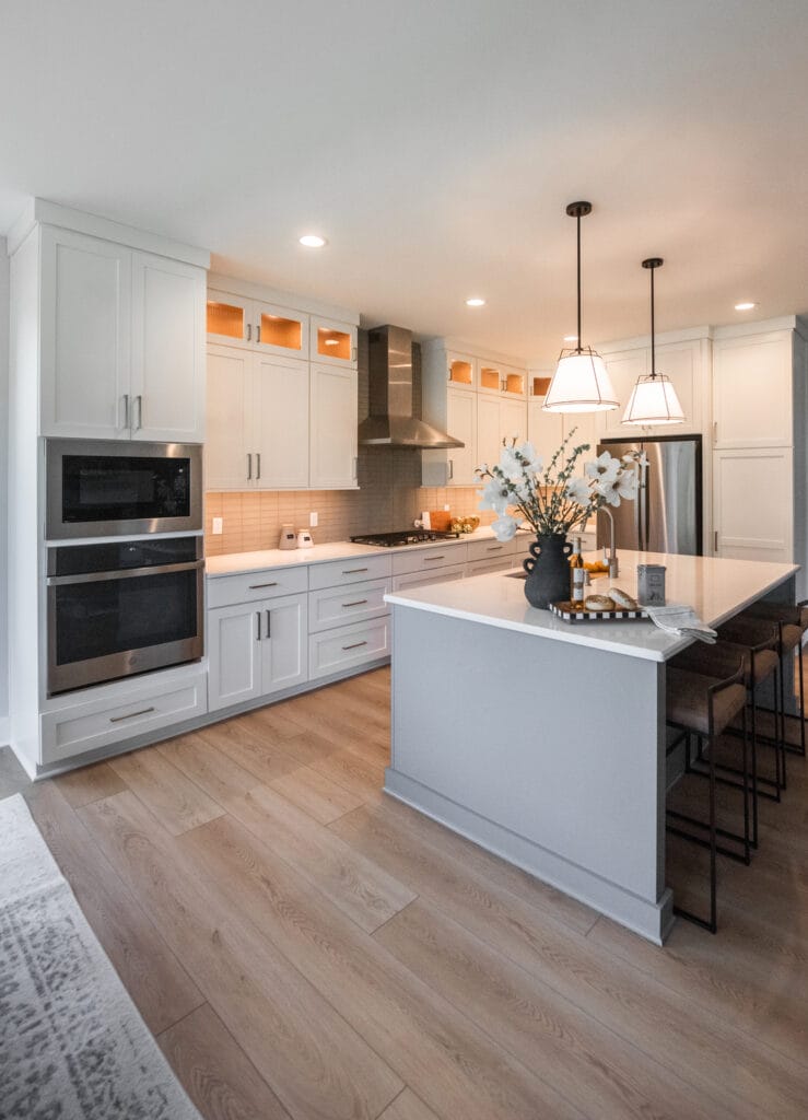 Modern kitchen with light grey cabinets and lights